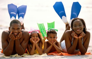 Family on the beach at Long Bay Resort.